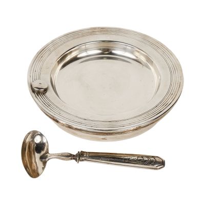 silver plate with spoon and spoon rest on a white background