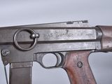 an old machine gun with a wooden handle on a white background