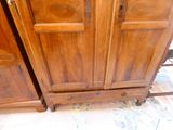 a wooden cabinet with a door and a drawer underneath it