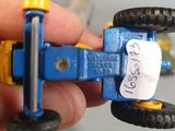 a person holding a toy car with a price tag on it