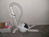 a vacuum that is sitting on the floor next to a box