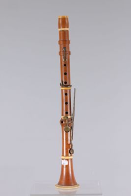 a close up of a musical instrument on a stand on a white surface