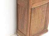 a tall wooden cabinet with a clock on top of it