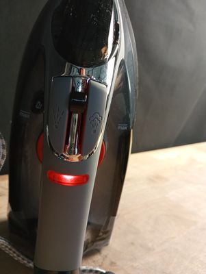 a black and silver coffee maker sitting on a wooden table