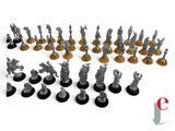 a bunch of small metal figurines are arranged on a white surface