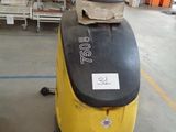 a yellow and black machine that is in a warehouse