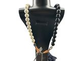 black and white beaded necklace with tassel on a mannequin
