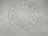 a close up of a white bag with a circular design on it