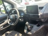 the interior of a small car with a steering wheel and dashboard