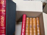 a lot of books that are in a box on the floor