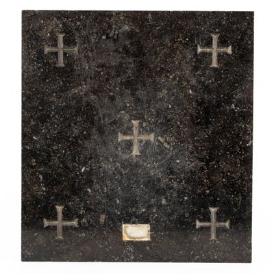 an old book with crosses on it sitting on top of a table