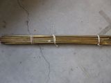 a close up of a bunch of metal rods on a concrete floor