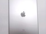 an apple ipad sitting on top of a white table next to a white wall