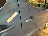 a blue car with a sticker on the side of it