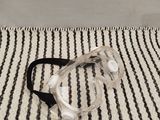 a pair of goggles sitting on a striped rug