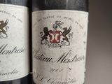 two bottles of wine sitting next to each other on a table
