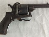 an old gun that is on a white cloth