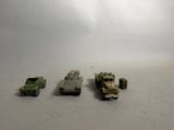 several toy vehicles are lined up in a row on a white surface