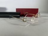 pair of glasses on a table next to a pair of glasses