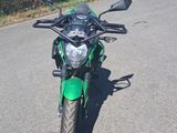 une moto verte garée sur le bord de la route