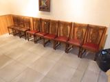 many wooden chairs lined up in a row in a room