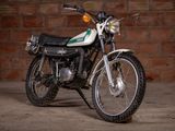 a motorcycle that is parked in front of a brick wall