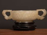 a white bowl sitting on top of a wooden table