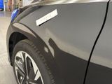 a close up of a black car with a sticker on it