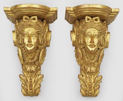 pair of gilded gold wall brackets with faces on each side