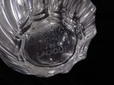 a glass ashtray with a baseball inside of it