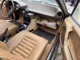 a car that is sitting in a lot with its door open