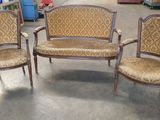 three chairs and a table in a room with a lot of furniture