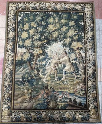 a tapestry with a picture of a man and a woman in the woods