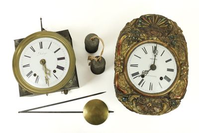 two clocks that are next to each other on the table