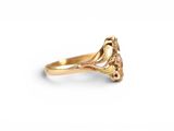 a close up of a gold ring on a white background