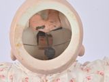 a small doll with a mirror on it ' s head