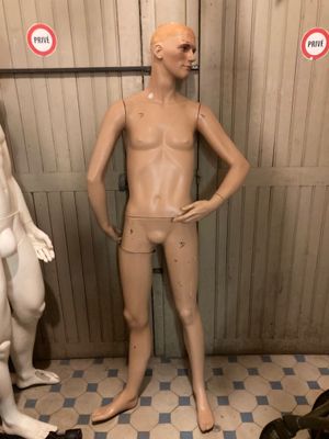 three mannequins standing next to each other in a room