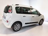 a picture of a small white car parked in a white room