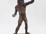 statue of a man holding a tennis racquet on a marble base