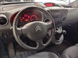 steering wheel of a car with a clock on the dashboard