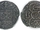 a close up of two silver coins with designs on them