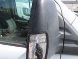 a white truck with a black side mirror on it ' s side