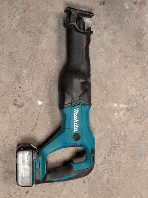 a close up of a cordless tool laying on the ground
