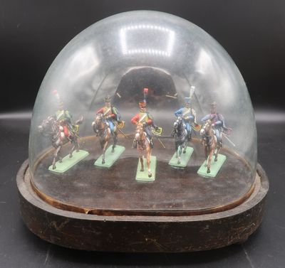 figurines of men riding horses under a glass dome on a wooden base