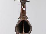 a sculpture of a violin that is hanging on a wall