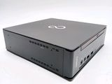 a small black computer sitting on top of a white table