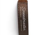 a brown leather keychain with a white lettering on it