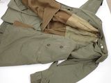 a jacket and pants laying on a white surface