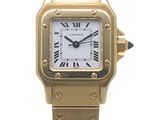 a close up of a gold wrist watch with roman numerals
