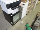 an image of a small refrigerator in a warehouse